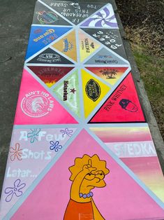 the simpsons character is painted on a long multicolored sidewalk board with words and symbols