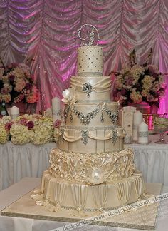 a three tiered wedding cake sitting on top of a table