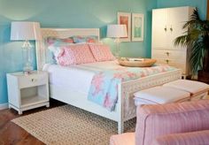 a bedroom with blue walls and white furniture