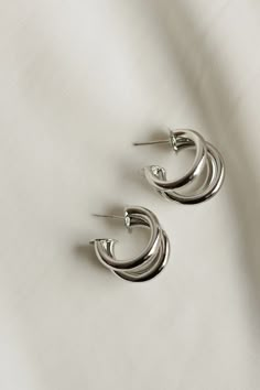 Classic + stylish -- our Triple Hoop Earrings are versatile for everyday wear. Whether they are dressed up or down, they make the perfect accessory. Available in both gold + silver. Includes two gold or silver plated triple hoop earrings Size Diameter: 20mm Width Diameter: 15mm All materials are lead & nickel free Silver Gold Earrings, Triple Hoop Earrings, Everyday Wear Jewelry, Hoop Earrings Silver, Accessories Jewelry Earrings, Bracelets Jewelry, Perfume Spray, Jewelry Companies, Earrings Collection