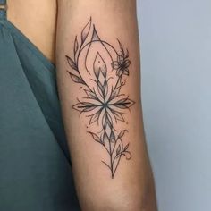 a woman's arm with a flower tattoo on it