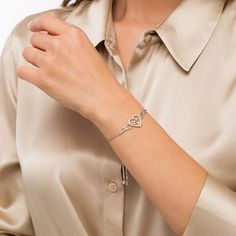 Celebrate the special bond between mother and child with this darling diamond bolo bracelet. Crafted in sterling silver, this look features an open diamond-lined heart flanked by a pair of polished wings. At the center, a petite diamond sparkles in a 10K gold motherly love design. Captivating with 1/10 ct. t.w. of diamonds and a brilliant buffed luster, this wheat chain bracelet adjusts up to 9.5 inches in length and secures with a bolo clasp and ball ends. Motherly Love, Winged Heart, Family Bracelets, Bolo Bracelet, Peoples Jewellers, Loose Stones, Bracelet Clasps, Love Design, Mother And Child