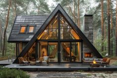 a house in the woods with lots of windows