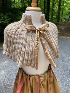 This terrific tweed shawl is hand knit of a soft beige wool with a subtle golden mustard thread throughout. The closure is a classic golden satin.  Whether you wear it to a ballgame or a Ren Faire, it is the perfect layering piece.  9" deep plus 4" collar Soft Beige, Shawls And Wraps, Layering Pieces, Scarf Wrap, Hand Knitting, Scarf Accessory, Shawl, Art Collection, Bathing Beauties