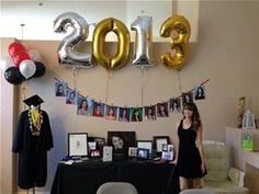 a decorated room with balloons and pictures on the wall for new year's eve