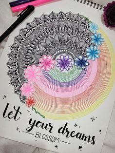 a coloring book with flowers and the words let your dreams blossom on it next to some crayon markers