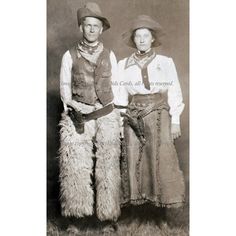 an old black and white photo of two people in cowboy outfits standing next to each other