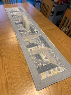 the table runner has two candles on it