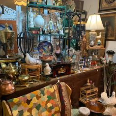 a room filled with lots of antique furniture and antiques on top of it's shelves