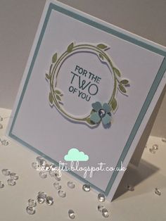 a close up of a card with water drops on the table and a white background