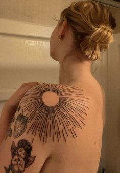 a woman with a sun tattoo on her back