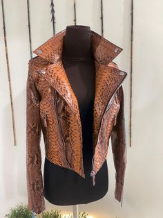 Woman's Python Leather Biker Jacket  PREMIUM QUALITY LUXURY STYLE Outside: Snakeskin  Accessories: golden color (please see the photo). All our products are 100% handmade, we always try to create interesting ideas to make your style unique. We use only the highest quality materials and accessories from around the world and only best leather from Indonesia. Before listing each new model undergoes different quality and usability tests at every stage of production. Every single piece is made by han Luxury Brown Biker Jacket With Zipper Closure, Luxury Brown Biker Jacket With Zipper, Luxury Brown Long Sleeve Biker Jacket, Designer Brown Leather Jacket With Zipper, Designer Brown Leather Jacket With Zipper Closure, Designer Brown Biker Jacket For Fall, Luxury Brown Biker Jacket, Designer Fitted Brown Biker Jacket, Luxury Fitted Brown Biker Jacket