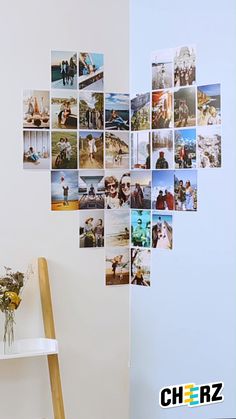 a ladder is next to a white wall with many pictures hanging on it and flowers in the corner