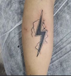 a man with a lightning tattoo on his arm