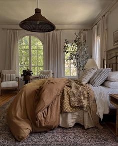 a bed room with a neatly made bed next to a window and a ceiling fan