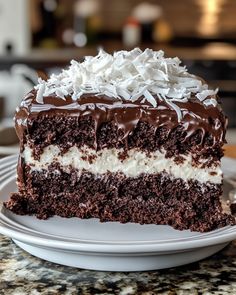 a piece of cake on a plate with chocolate frosting and coconut sprinkles