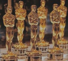 the oscars are lined up in front of each other with their statues on them