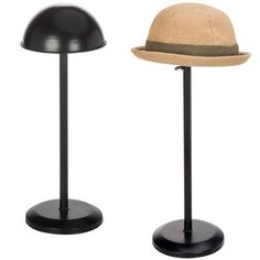 two hats sitting on top of black stands