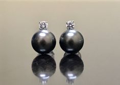 DeKara Designs Clearance Elegant Art Deco/Modern Handmade 14K White Gold Diamond and Tahitian 10 MM South Sea Black Pearl Earrings. Metal- 14K White Gold, .583. Stones- 2 Tahitian Black Pearls 10 MM, 2 Round Diamonds G-H Color VS2 Clarity 0.30 Carats. Beautifully Handmade 14K White Gold Diamond Black Pearl Stud Earrings. These earrings feature two beautiful black pearls that are carefully selected for color and luster. There are two beautiful round diamonds that are prong set on top of the pearl Luxury Black Pearl Drop Jewelry, Black Pearl Earrings Tahitian, Classic Tahitian Pearl Earrings For Anniversary, Classic Black Tahitian Pearl Earrings, Luxury Black Tahitian Pearl Earrings, Black Round Pearl Earrings For Formal Occasions, Formal Black Tahitian Pearl Earrings, Elegant Black Tahitian Pearl Earrings, Art Deco Pearl