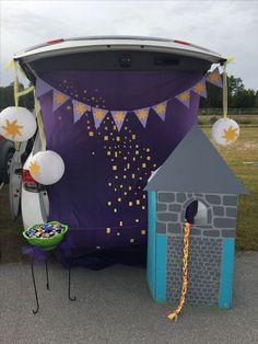 the back of a van is decorated with balloons and streamers as it sits outside