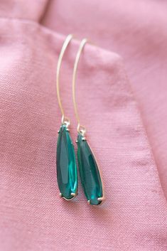 Emerald Green Pendant Earrings ⟡ all items are designed and handcrafted in our studio ⟡ Long green glass and gold teardrop earrings. Introducing our emerald pendant earrings - a stunning addition to any jewelry collection. They feature a beautiful glass stone set in a gold plated setting, creating a perfect balance of elegance and luxury. The long ear wire adds a dramatic touch to any outfit, making them perfect for both formal and casual occasions. OVERVIEW-3" in length-glass crystals-gold plat Glass Drop Earrings With Matching Set, Glass Teardrop Jewelry With Matching Earrings, Nickel-free Glass Drop Jewelry, Elegant Glass Drop Jewelry, Elegant Drop Glass Jewelry, Elegant Drop-shaped Glass Jewelry, Green Glass Dangle Jewelry, Nickel-free Teardrop Glass Jewelry, Elegant Glass Drop Earrings