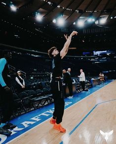 a man standing on top of a basketball court