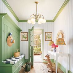 a hallway with green painted walls and white trim on the ceiling, two stuffed animals sit in front of an entry door