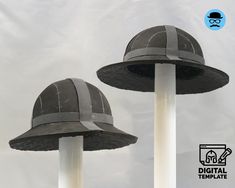 two gray hats sitting on top of white poles