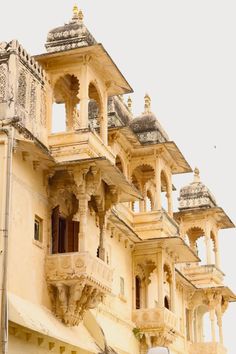 an old building with many windows and balconies on the top floor, in india