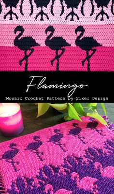 a crocheted blanket with pink and black flamingos on it, next to a candle