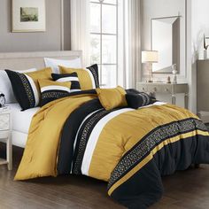 a bed with yellow and black comforters in a room