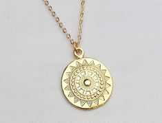 Sun medallion gold plated necklace. The sun charm is approx 2.5 cm high; all components of the necklace are gold plated. This minimal necklace can be worn layered or on its own. Model wears length 60cm. For other gold plated layering necklaces, see these listings: https://www.etsy.com/uk/shop/Kemeria?ref=seller-platform-mcnav&section_id=26436855 The necklace will be packaged in tissue paper and an organza bag. Celestial Gold Necklace For Festival, Gold Circle Jewelry For Festivals, Gold Circular Jewelry For Festivals, Gold Circular Festival Jewelry, Gold Sun And Moon Design Jewelry For Festivals, Gold Jewelry With Sun And Moon Design For Festivals, Gold Sun And Moon Festival Jewelry, Gold Necklace With Sun Design Round Pendant, Gold Sun Design Round Pendant Necklace