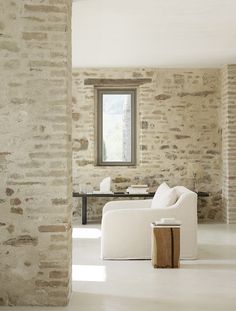 a living room filled with furniture next to a window