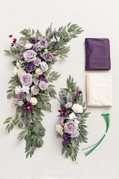 two pieces of purple and white flowers are laid out on the ground next to each other