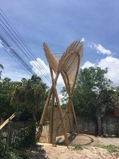 a wooden sculpture in the middle of a yard