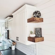 the kitchen is clean and ready for us to use it's shelves are made out of wood