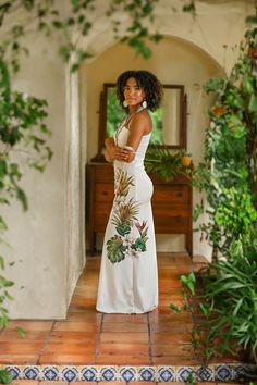 a woman in a white dress is posing for the camera