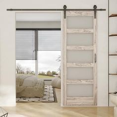 an open sliding door in a living room with white walls and wood flooring, along with a painting on the wall