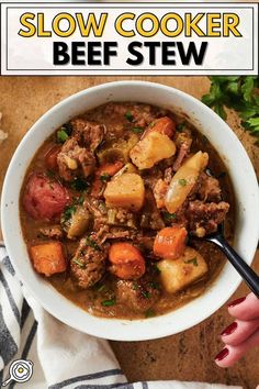 a bowl of slow cooker beef stew with potatoes and carrots