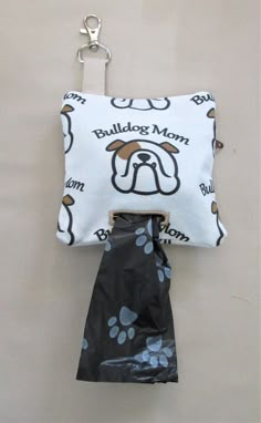 a bag with a dog's paw print on it is hanging from a hook