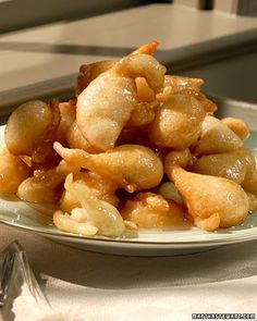 a white plate topped with fried food on top of a table