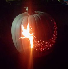 a lit pumpkin with a bird on it