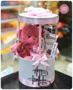 a pink teddy bear in a gift basket