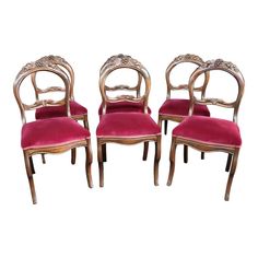 four chairs with red velvet upholstered seats