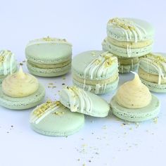 several macaroons with white frosting and gold sprinkles