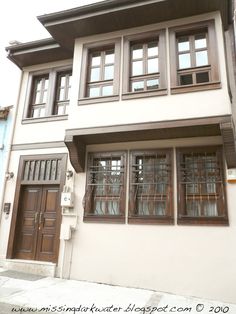 a white house with wooden doors and windows