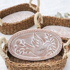 three woven baskets with decorative designs on them