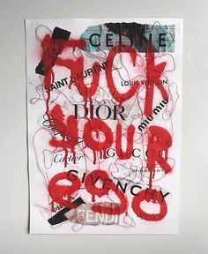 a piece of paper that has some type of graffiti on it with words written in black and red