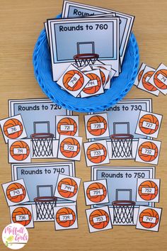 basketball themed rounding to 70 game cards on a table with a blue plate and orange hoop