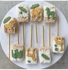 a white plate topped with lots of food on top of a wooden skewer